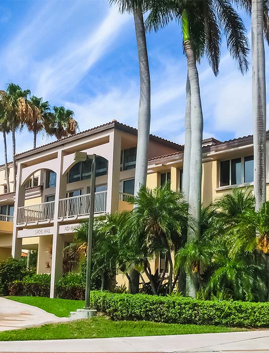 Exterior custom home build with multi stroy design palm trees and blue skies