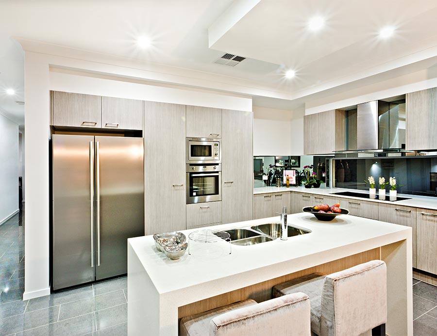 Modern custom home with kitchen counter top with a fridge and pantry